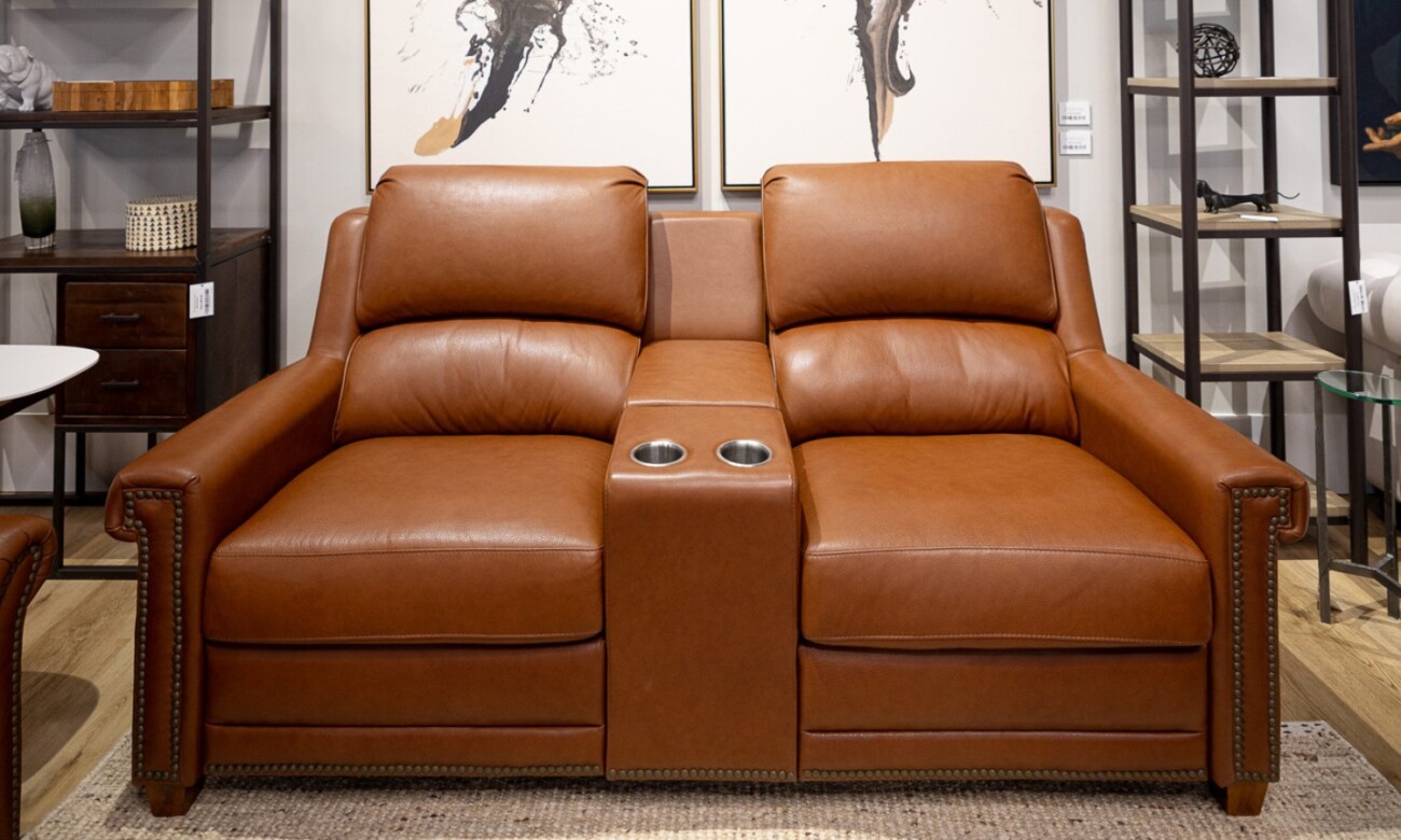 Leather theater seating compared to fabric seating showing durability and comfort differences.